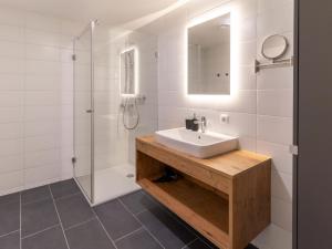a bathroom with a sink and a shower at Apartment be calm by Interhome in Mieming +16 photos