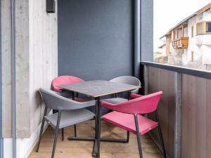 a table and chairs on the balcony of a building at Apartment be calm by Interhome in Mieming