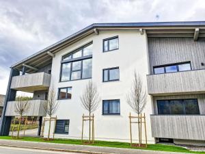 a white building with black windows at Apartment be calm by Interhome in Mieming