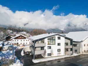 an apartment building with a snow covered roof at Apartment be calm by Interhome in Mieming