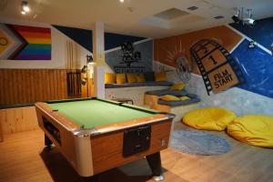 a room with a pool table and two bean bags at Onefam Sants in Barcelona