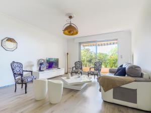 a living room with a couch and a table at Apartment Les Balcons d'Eze-3 by Interhome in Èze