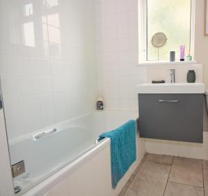 a white bathroom with a tub and a sink at Spacious Double Room with Private Bathroom in Streatham Common, Southwest London in Streatham Vale