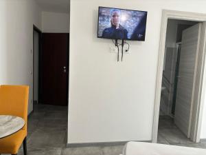 a tv on a wall in a room at Affittacamere Valentina in Verona