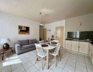 a living room with a table and a couch at PETIT CAPUCIN in Carcassonne