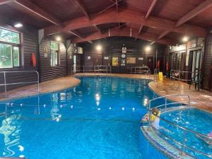 a large swimming pool in a building with a large swimming pool at Claire’s place in Hayle