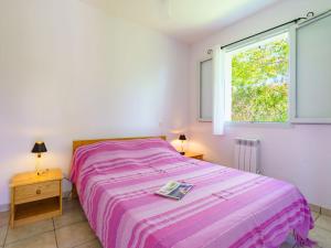 a bedroom with a bed and a window at Holiday Home Les 7 Nains-5 by Interhome in Bidart