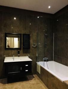 a bathroom with a bath tub and a sink and a bath tub at Marrakech villa in Marrakech