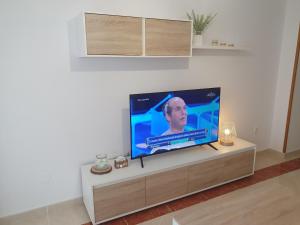 a flat screen tv sitting on a stand in a living room at Mirasol in Viveiro
