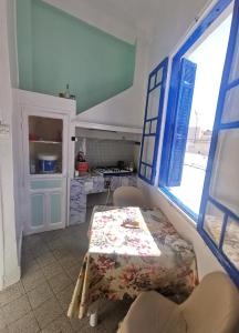 a kitchen with a table in a room at Dar mima baya in Tunis