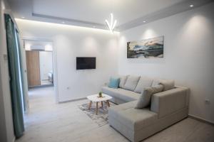 a living room with a couch and a table at Apartments Cota Guesthouse in Ulcinj