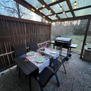 a table and chairs on a patio with a piano at Villa Garpenberg in Garpenberg