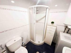 a white bathroom with a shower and a toilet at Apartamento en Aguadulce con vistas al mar in Aguadulce +24 photos