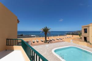 a balcony with a swimming pool and the ocean at CT Las Tres Palmeras in Valle Gran Rey