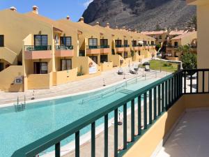 a view of the pool from the balcony of a hotel at CT Las Tres Palmeras in Valle Gran Rey