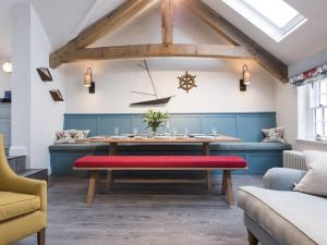 a dining room with a table with a red bench at Holiday Home Iris by Interhome in St Ives