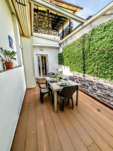 a patio with a table and chairs on a deck at - La Grotta del Mare- Beach and Apuan Alps- in Marina di Carrara