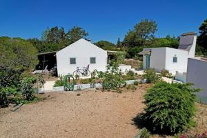 a house with a bike parked in front of it at Casa da Horta in Carvalhal