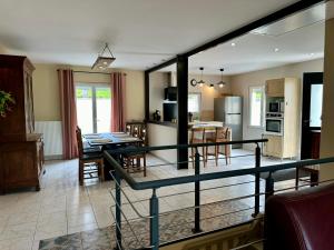 a kitchen and living room with a table and chairs at Aux Prés Bressot in Buncey