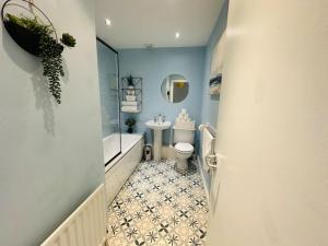 a bathroom with a tub and a toilet and a sink at Stunning semi-detached townhouse, Holywood, Sleeps 6 - 10 mins from Belfast in Belfast