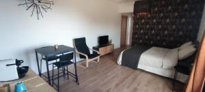 a bedroom with a bed and a desk and a table at CASAPIETRA in Brando