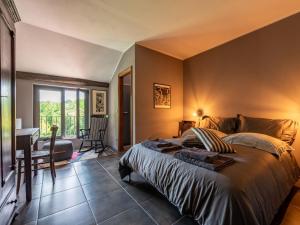 a bedroom with a bed and a desk and a window at Holiday Home Beppe Country House by Interhome in Serravalle dʼAsti