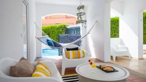 a living room with a hammock in a house at Villa Del Sol by Algarve Vacation in Quarteira