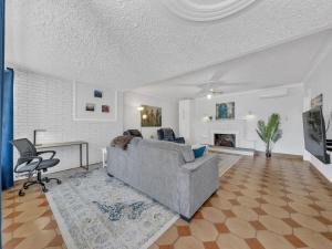 a living room with a couch and a table at Parkside Flat - Seacliff Beach Suites in Leamington