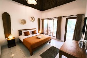 a bedroom with a bed and a large window at Olo Surf Nature in Uluwatu +63 photos