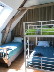 two bunk beds in a room with a attic at La Marchanderie in Spay