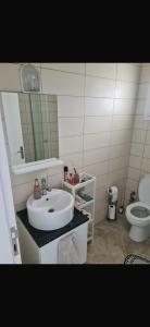 a bathroom with a sink and a toilet at Girne Alsancak Harika Konumlu Daire in Kérynia