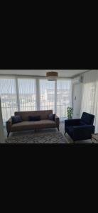 a living room with a couch and two chairs at Girne Alsancak Harika Konumlu Daire in Kérynia