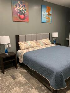 a bedroom with a bed with two night stands and two lamps at Hotel Residencial Edzná Calle 10 in Campeche +45 photos