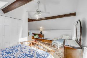 a bedroom with a bed and a ceiling fan at Linden Tree Carriage House in Newburyport