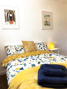 um quarto com uma cama com um cobertor azul em (KB45) Cosy & quaint 2 bed house. Pet friendly. em Roffey