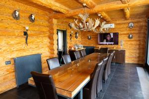 a dining room with a large wooden table and chairs at Mountain Lake JBS in Focşani