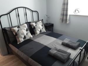 a bed with pillows on it in a bedroom at The Maltings - Apartments 1 in Shepton Mallet