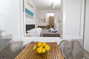 una habitación con una mesa con un bol de fruta en ella en Hotel Stella Mare en Zavala