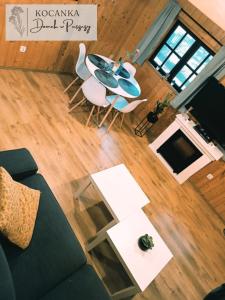 an overhead view of a living room with a table and chairs at Domek w Puszczy ,,Kocanka" in Mężyk