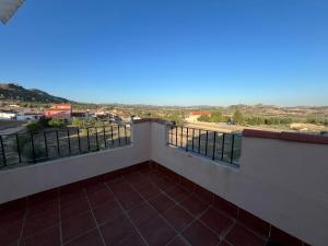 a balcony with a view of the city at Alojamiento Rural Ikigai in Losa del Obispo