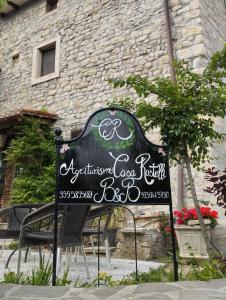 a sign for a restaurant in front of a building at Agriturismo Casa Rastelli in Monteorsello