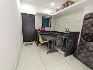a small kitchen with a table and a sink at Veer Homestay in Garudeshwar