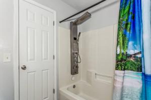a bathroom with a tub and a shower curtain at 3192 Birdseye Cir in Gulf Breeze +24 photos