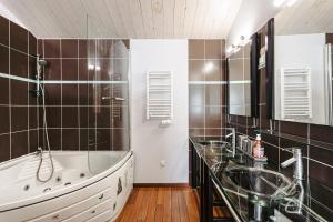 a bathroom with a tub and a sink at Maison de vacances hyper centre in Sainte-Marie-de-Ré +18 photos