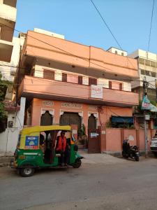 a small car with a person in it on a street at NILAY House Varanasi Near Assi Ghat in Varanasi