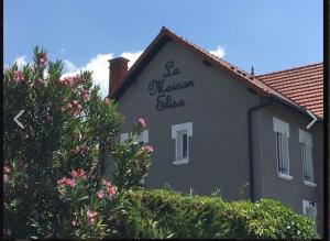 a building with a sign on the side of it at Studio La Maison Elisa in Aix-les-Bains