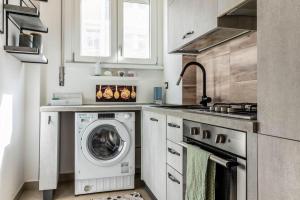 a kitchen with a washing machine and a sink at [20 minuti dal Duomo] Milano Smart Apartment in Sesto San Giovanni