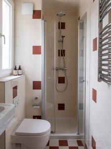 a bathroom with a shower and a toilet and a sink at Hotel le 18 Paris in Paris