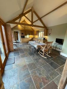 a large open living room with a table and chairs at Stunning rural Barn Conversion in Worcester