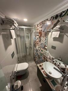 a bathroom with a shower and a toilet and a sink at Sera Homes Kaleici Oldtown in Antalya